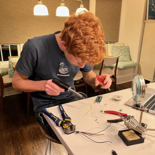 Ben soldering electronics for the Ice Cold Beer arcade game