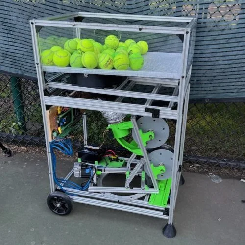 The completed tennis ball machine on a tennis court