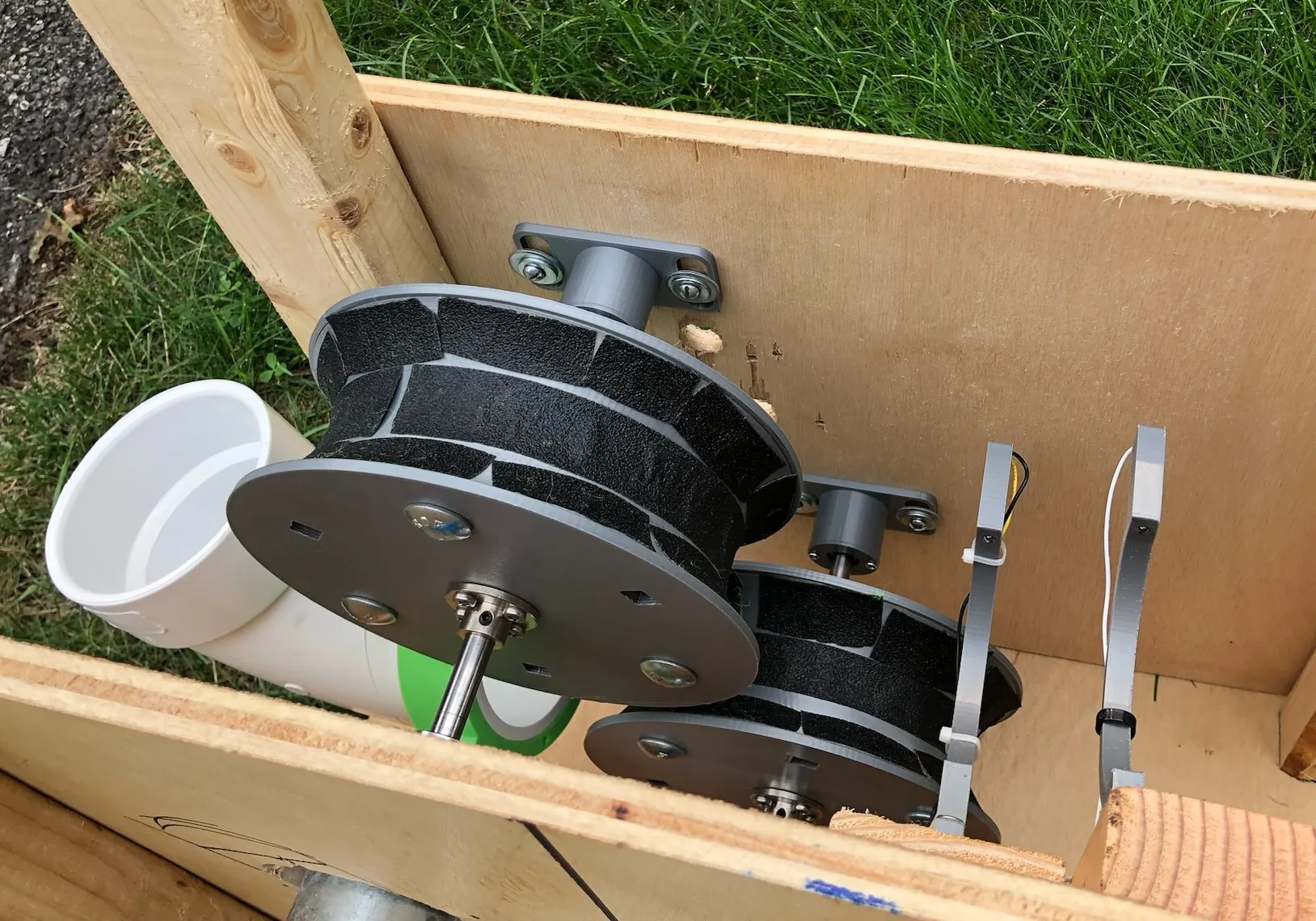 Tennis-ball machine launch wheels with grip tape